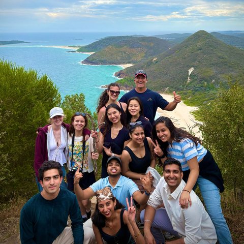 A Passport People group on a headland above the coast